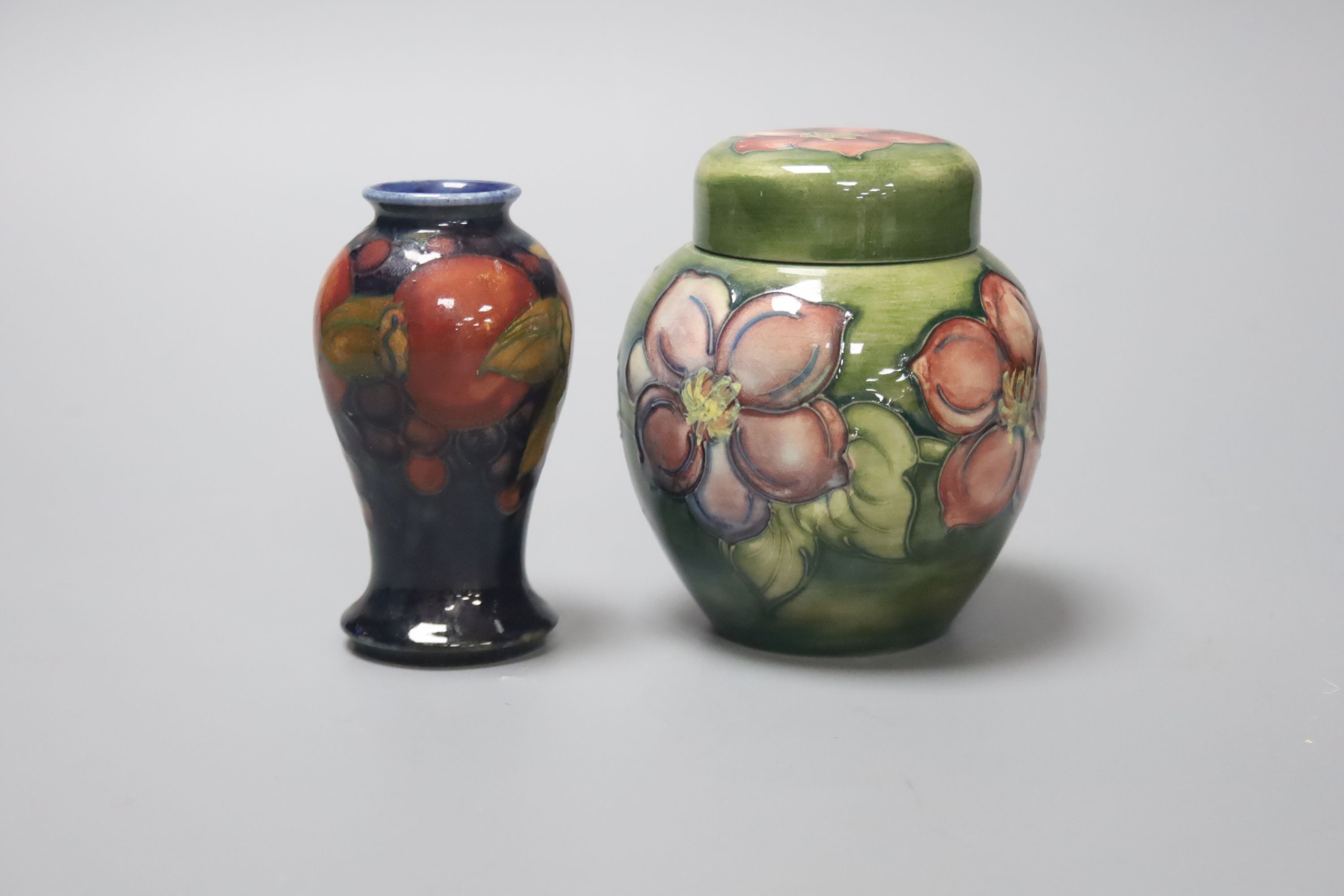 A Moorcroft Hibiscus jar and a similar Pomegranate vase, height 11cm